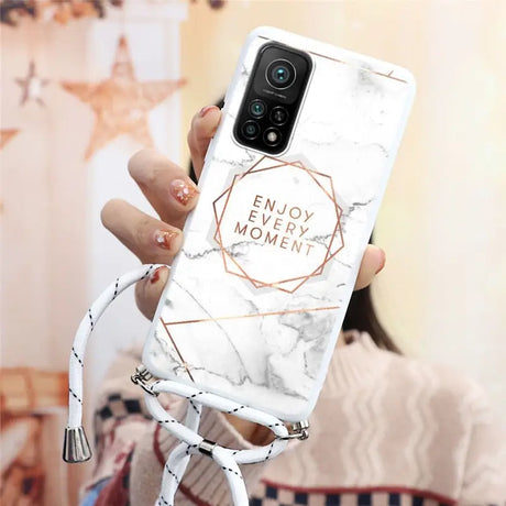 a woman holding a white marble phone case with the words enjoy me