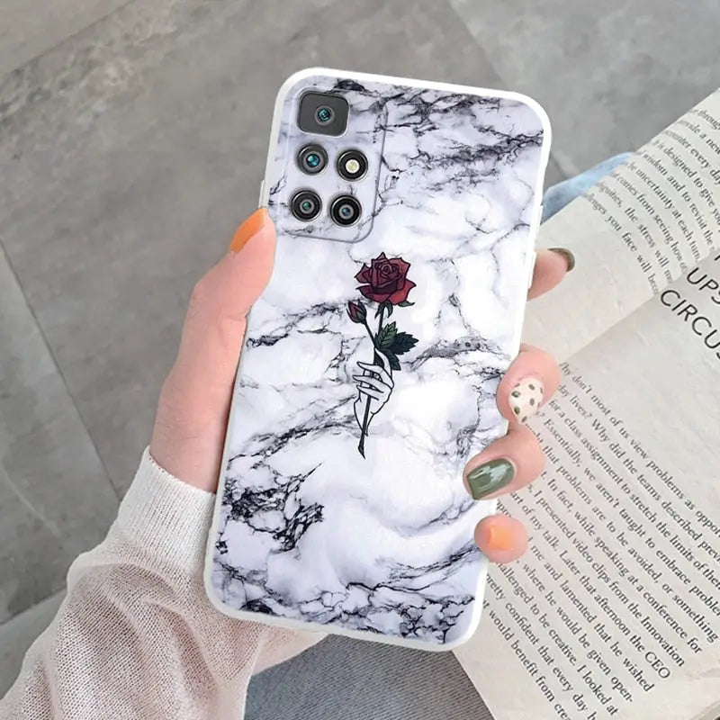 a woman holding a phone case with a rose on it