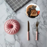 a marble table with a pink cake and a pink plate