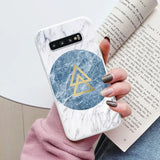 marbled phone case with a triangle and a gold triangle on it