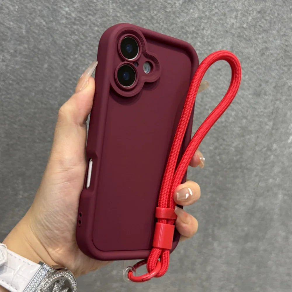 A maroon phone case with a red wrist strap.