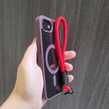 Mauve phone case with red wrist strap.