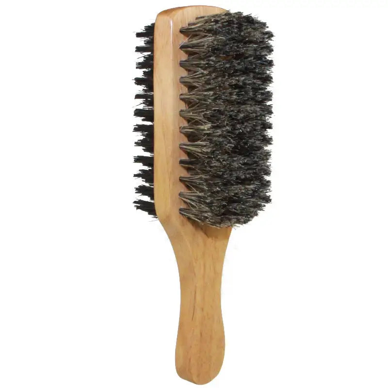 a wooden brush with black bristles on it