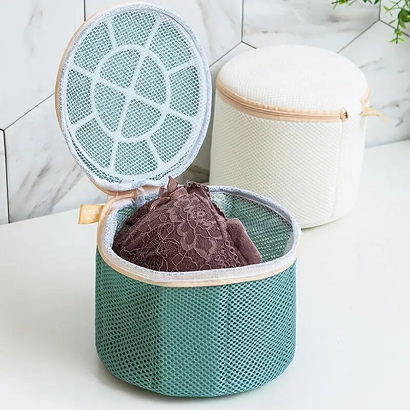 there is a basket with a cloth inside of it on a counter