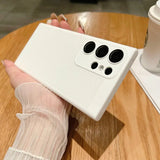 a hand holding a white phone case