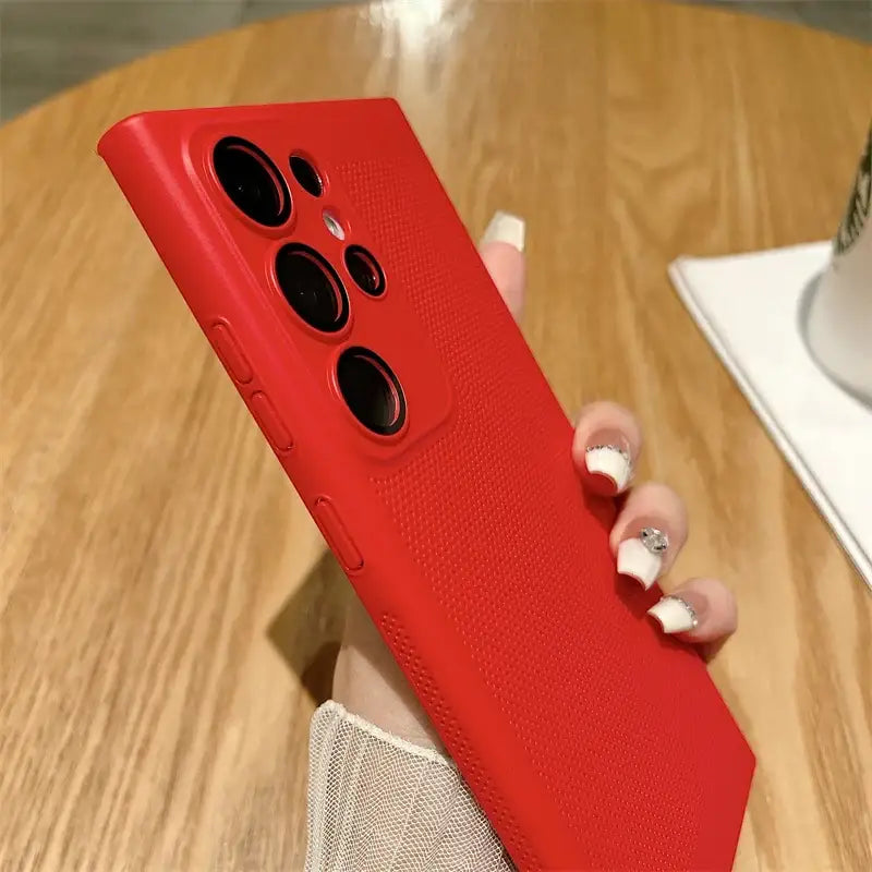 a woman holding a red phone case