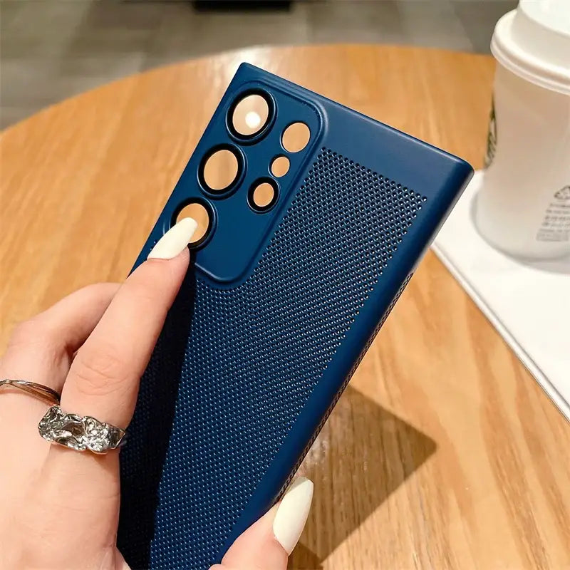 a woman holding a phone case with a finger grip