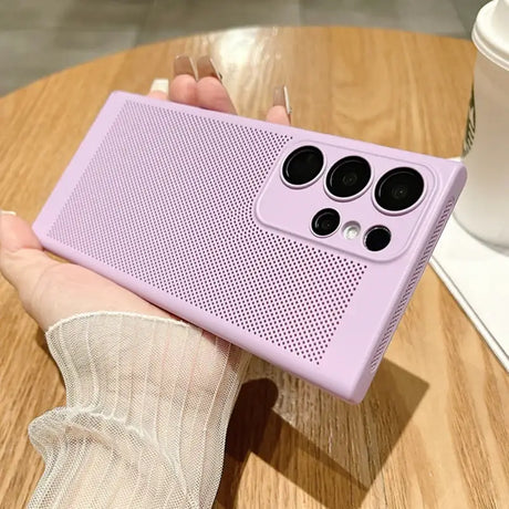 a woman holding a purple phone case