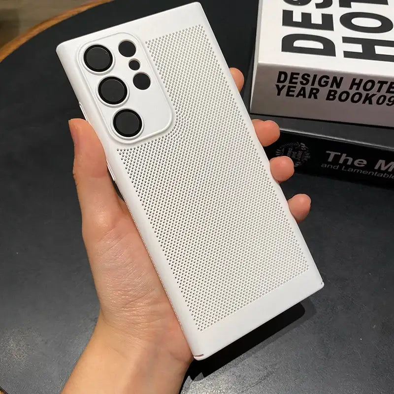 the case is made from white plastic and has a white plastic cover with a black dot pattern