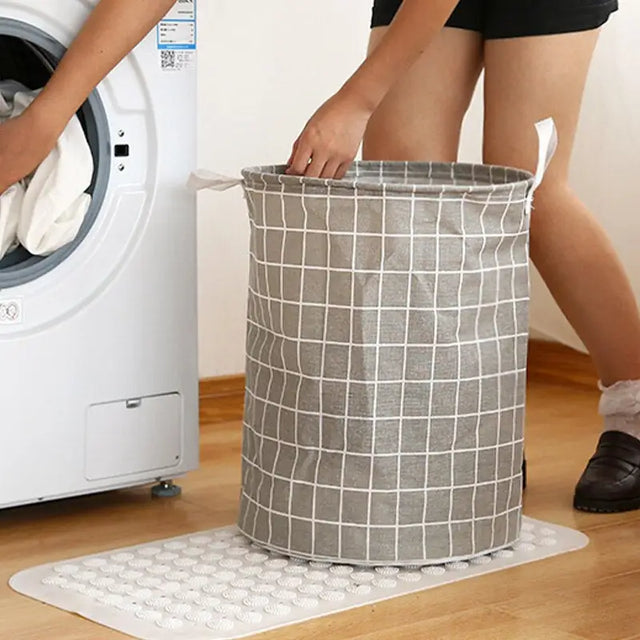 a woman putting a laundry bag into a washing machine