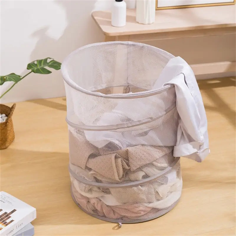 a mesh laundry basket with a white shirt on it