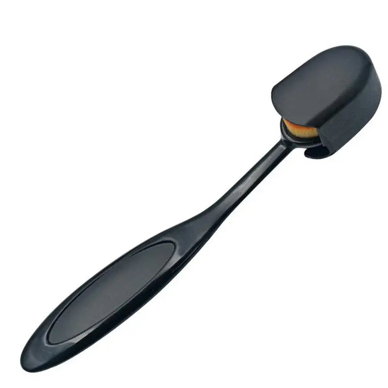 a black spoon with a wooden handle