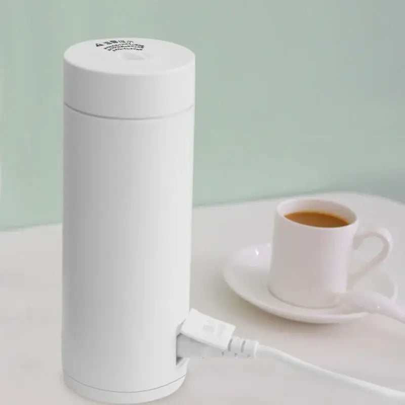 a white coffee grinder sitting on a table