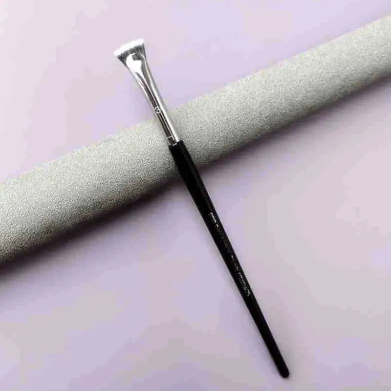 a brush with a white handle on a purple background