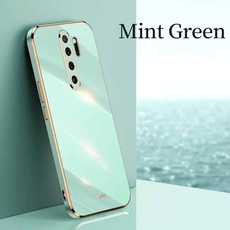 the mint green iphone case is shown on a table