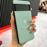 Mint green Google Pixel smartphone held in a hand with decorated nails.