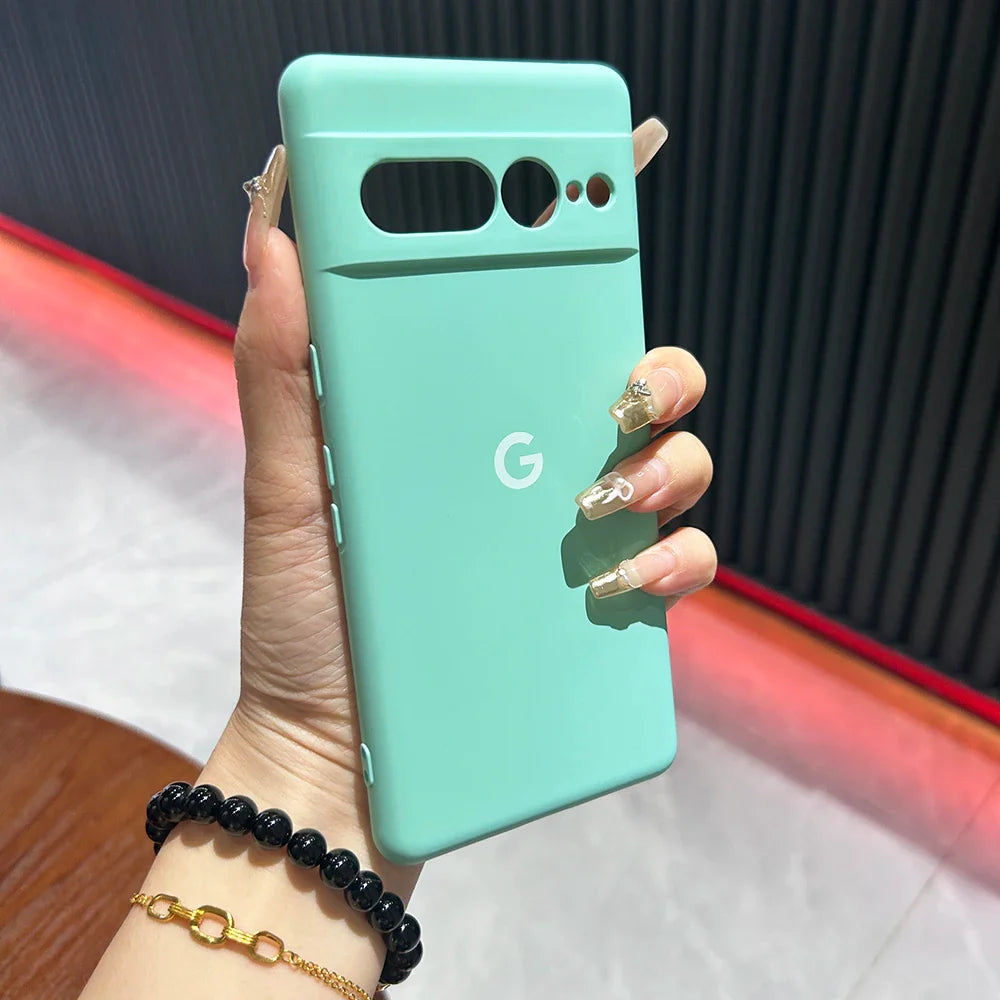 Mint green Google Pixel smartphone held in a hand with manicured nails.