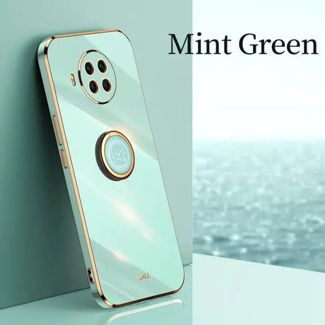 the mint green iphone case is shown on a table