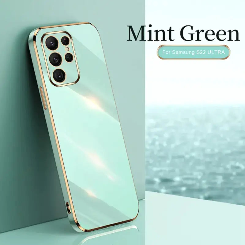 the mint green iphone case is shown on a table
