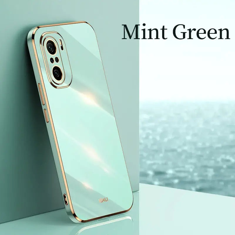 the mint green iphone case is shown on a white surface