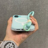 Mint green phone case with a wrist strap.