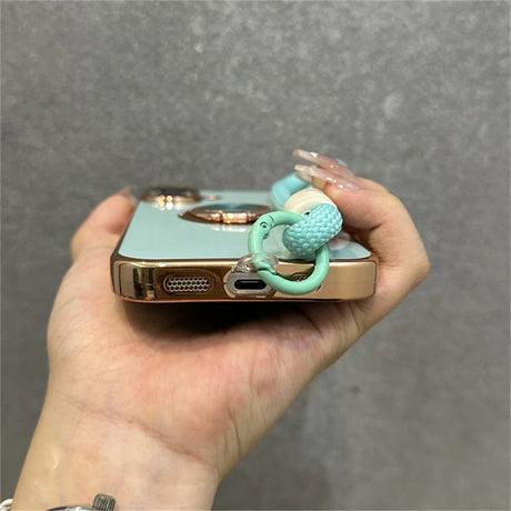 Mint green phone case with beaded strap.
