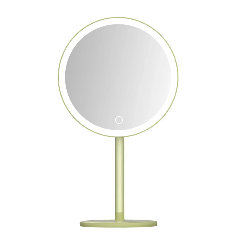 a mirror on a stand with a light green base