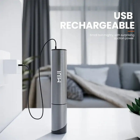 there is a silver portable charger sitting on a table