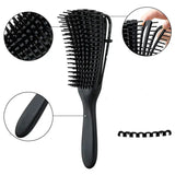 a close up of a hair brush with a black handle