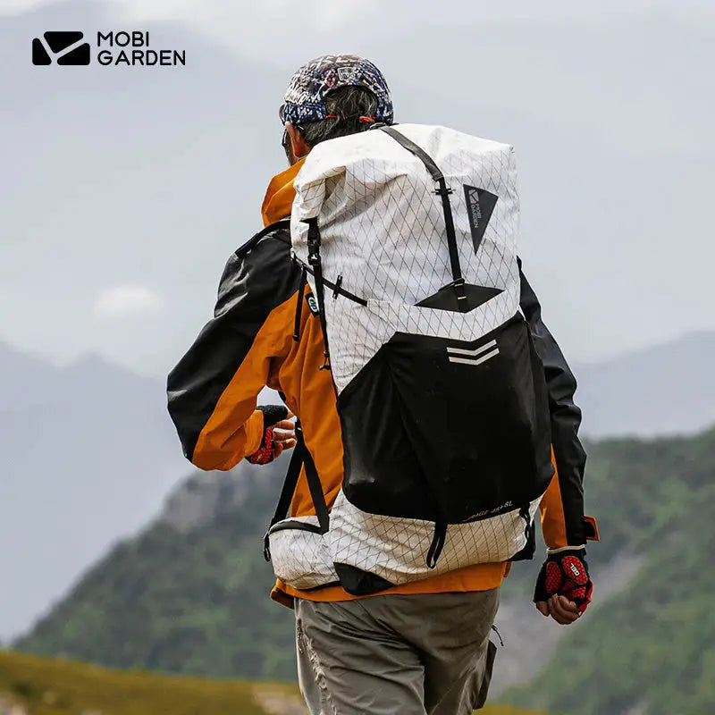 a man with a backpack walking on a mountain