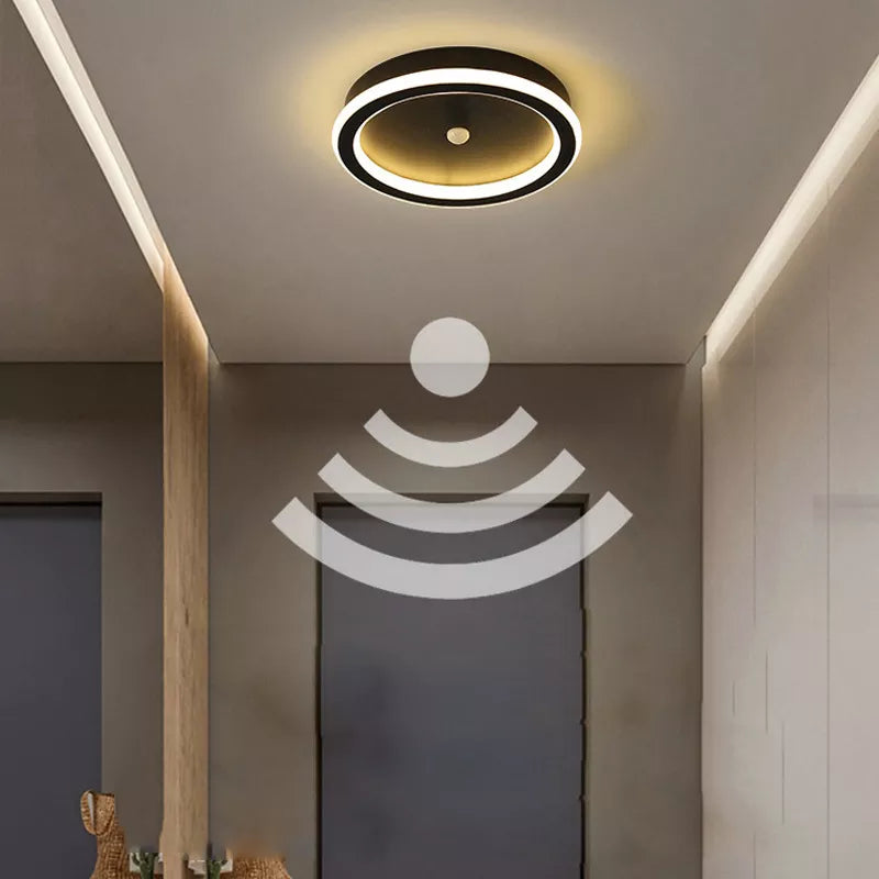a modern bathroom with a round light fixture