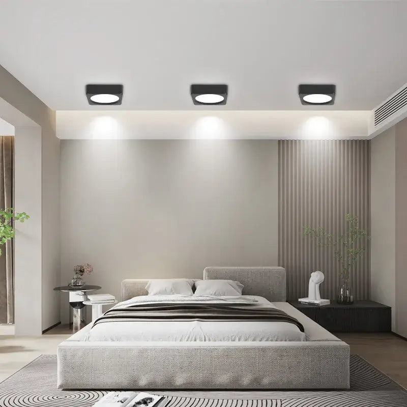 A modern bedroom with a large bed and a large window