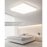 a bedroom with a bed and a light on the ceiling