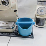 a coffee maker and a cup on a tray