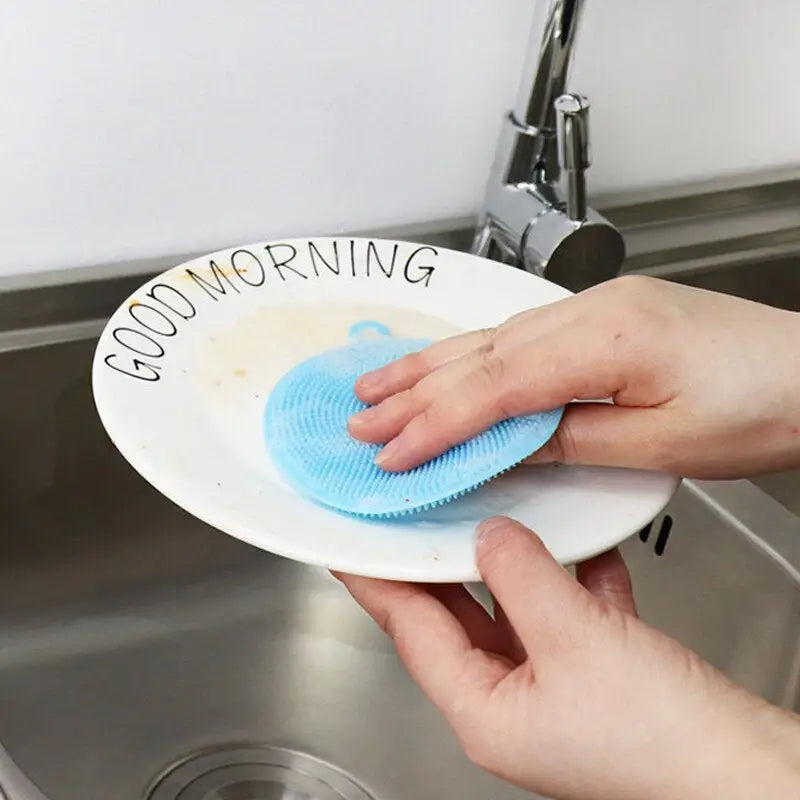 someone cleaning a sink with a sponge