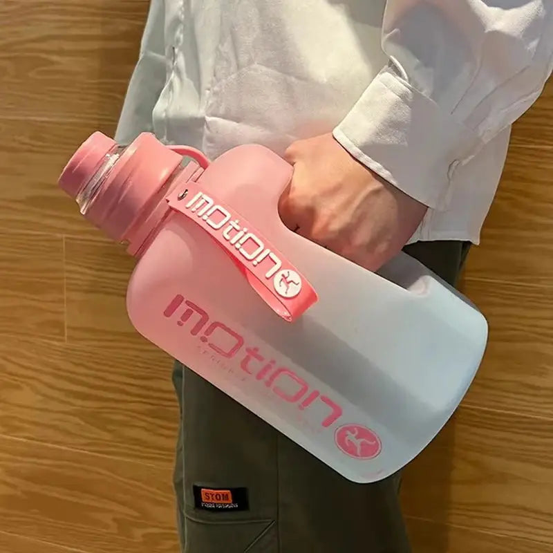 a person holding a water bottle with a pink lid