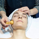 a woman getting her face massage at the spa