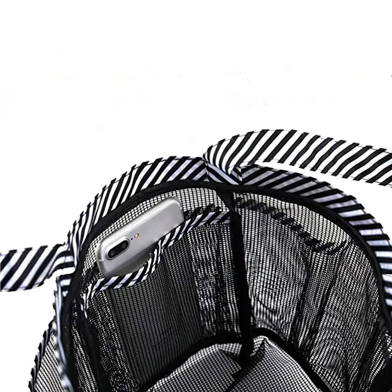 a black and white striped bag with a phone in it