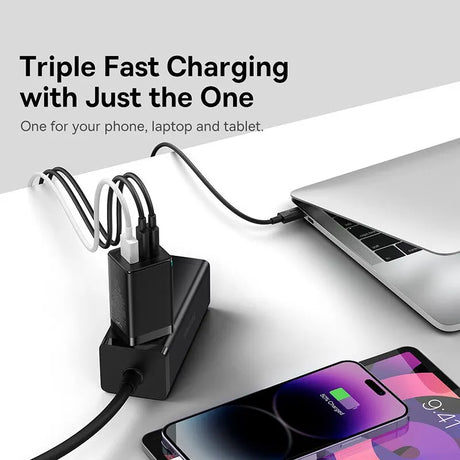 Multi-port charging adapter connected to a laptop, smartphone, and additional cables.