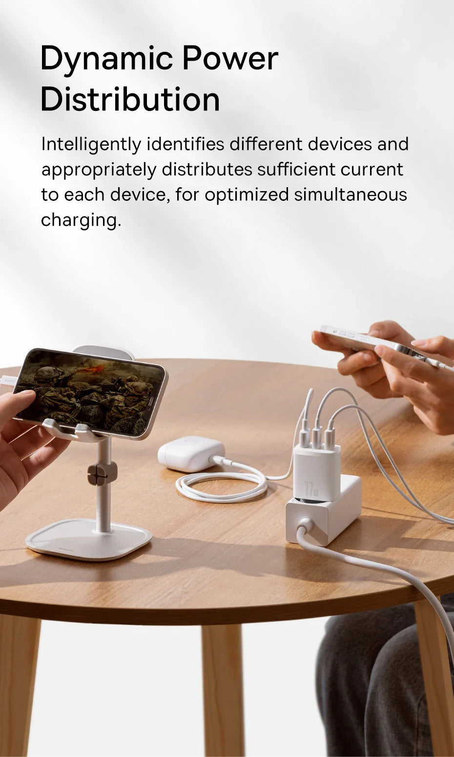 Multi-port charging station with a phone stand on a wooden surface.