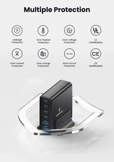 Multi-port USB charging station with a black rectangular body sitting on a clear plastic base.