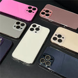 Multiple colorful iPhone-style phone cases with camera lens cutouts.