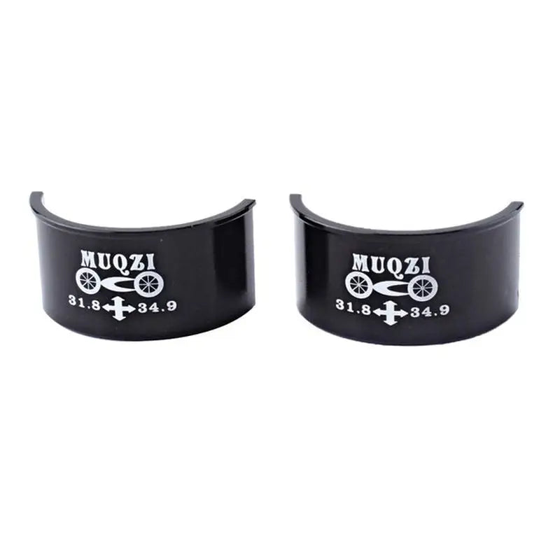 a pair of black cuff rings with the words muzi on them