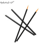 a set of four black and orange paint brushes with a white tip