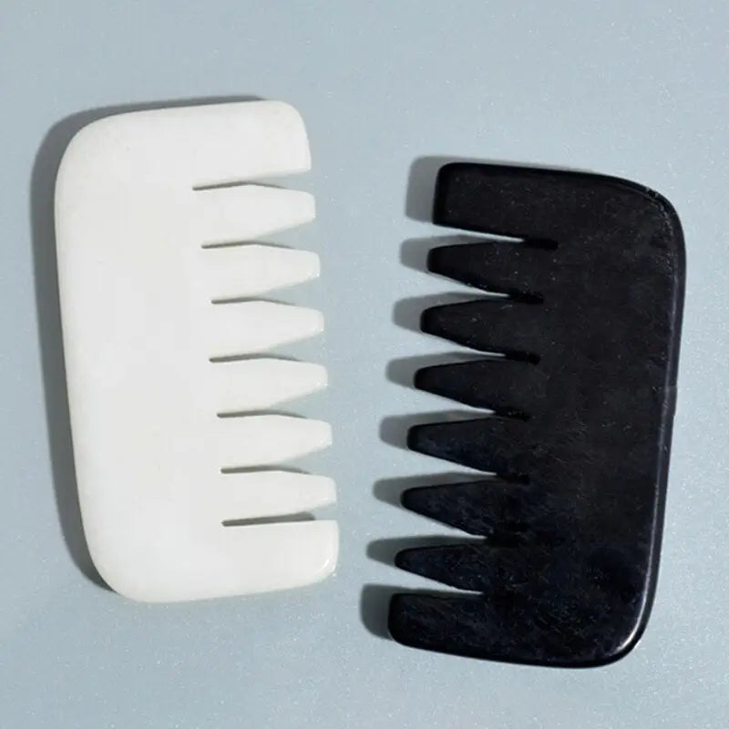 a pair of black and white plastic combs