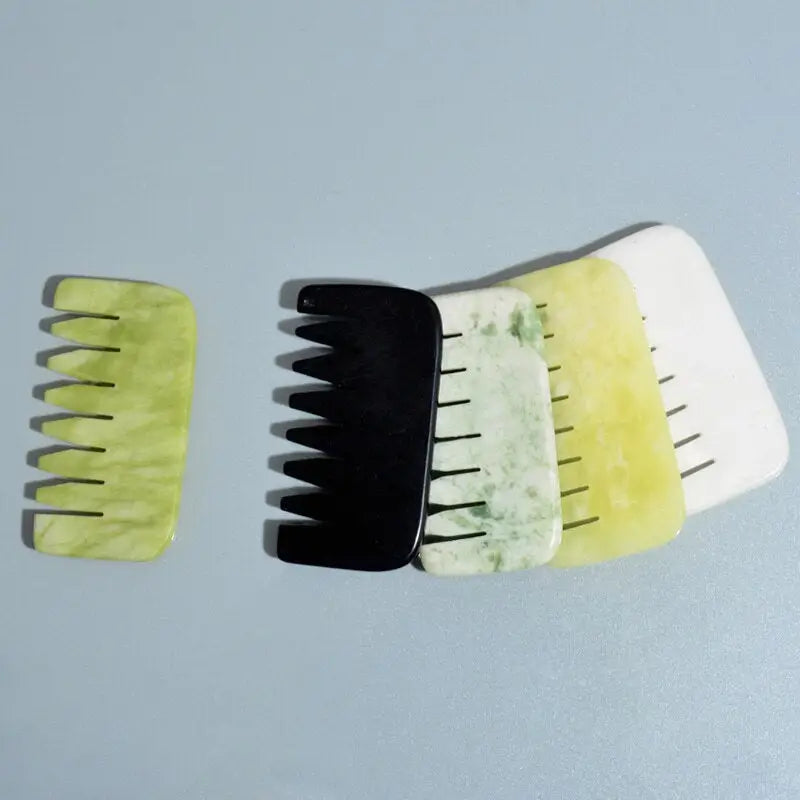 three different types of tooth brushes on a gray surface