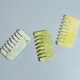 a pair of green and white hair clips