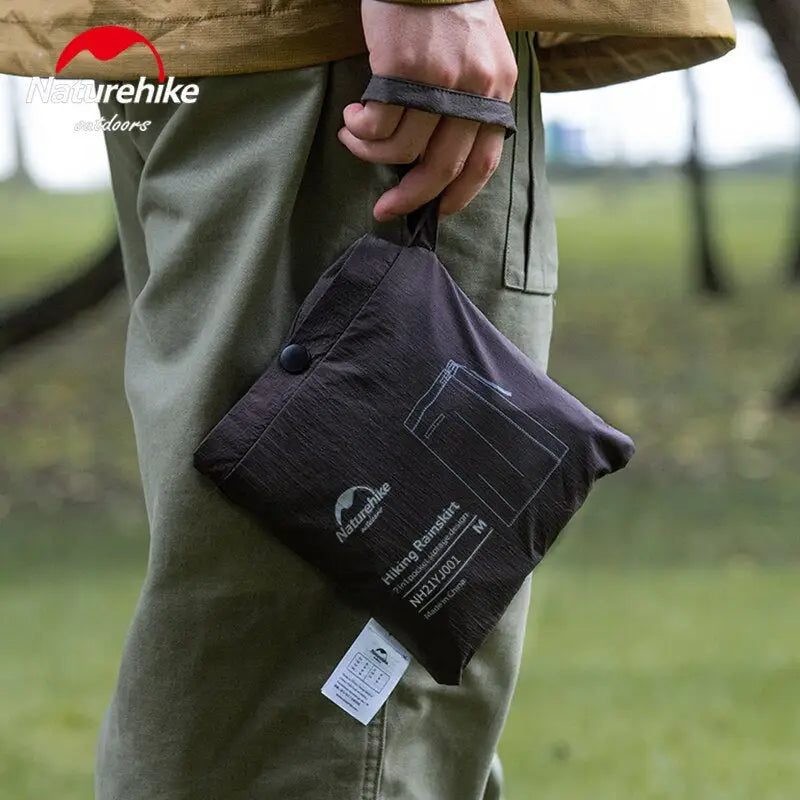 a man holding a black bag with a white label