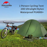 a tent and a bike are on the grass