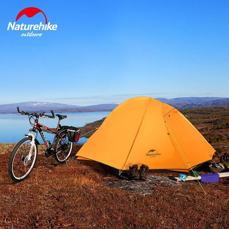 a tent and a bicycle on a hill